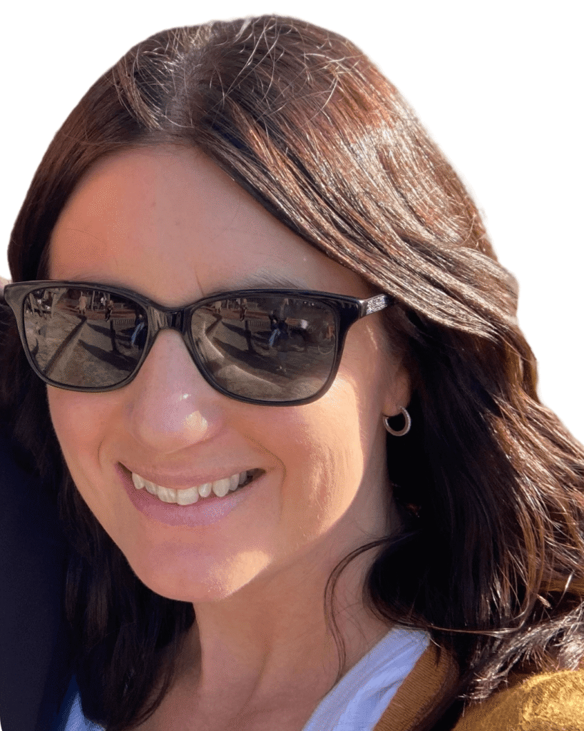 Woman smiling with dark brown hair, wearing glasses