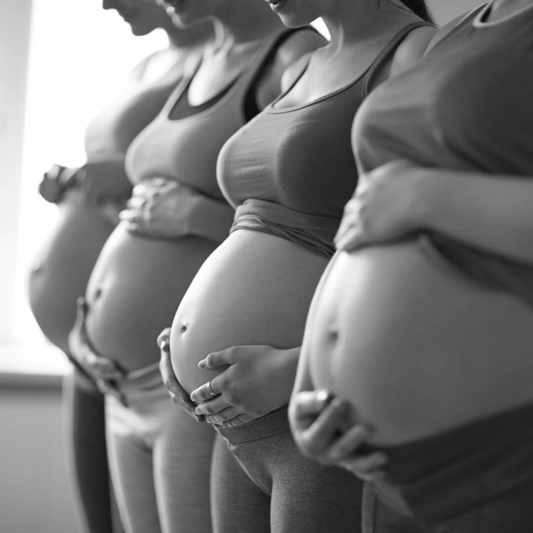 Hypnobirthing women cradling baby bumps