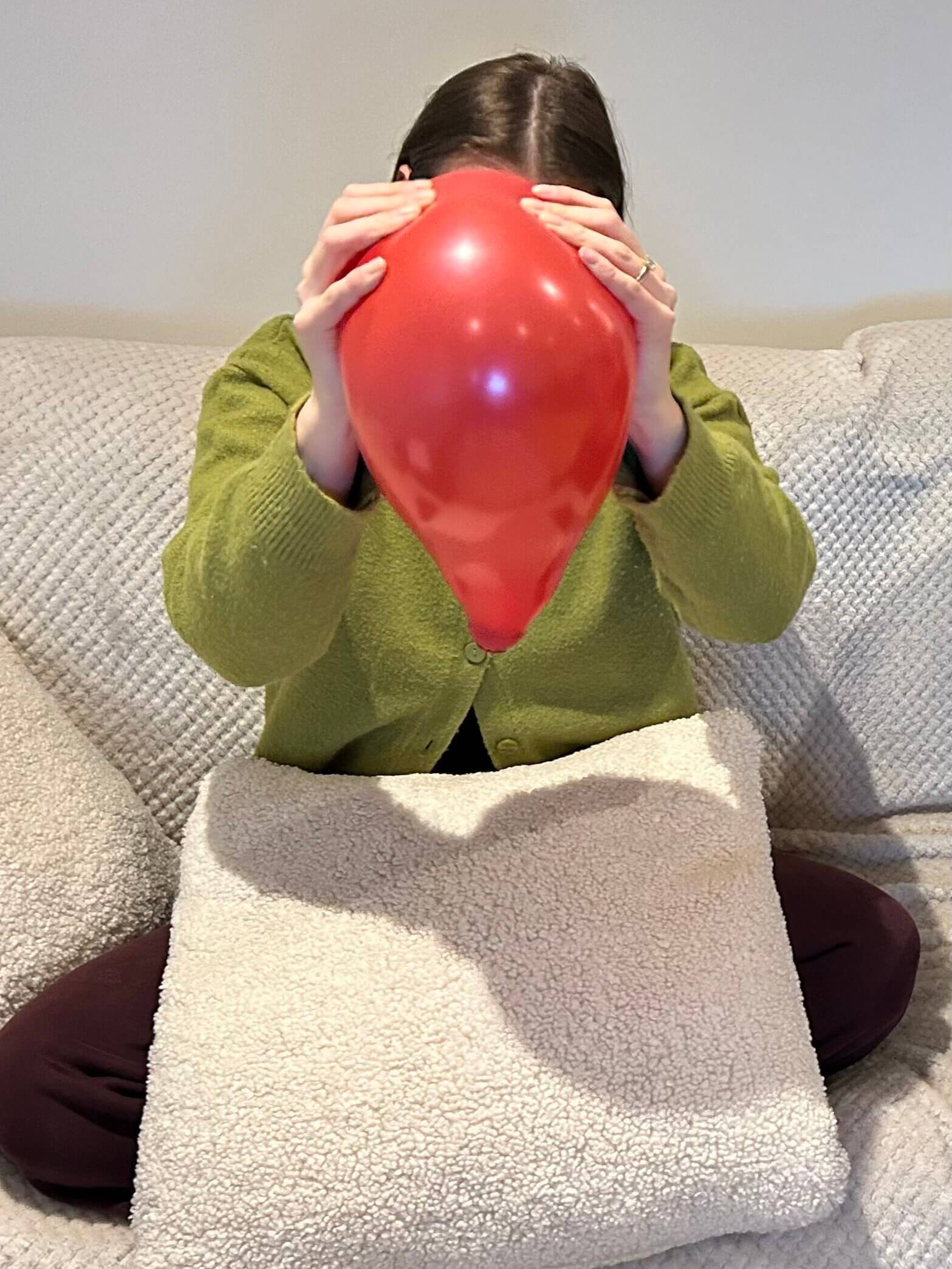 Pregnant woman learning about the muscles of the uterus with a balloon and ping pong ball