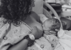 A black and white image of a breastfeeding mother wondering what the benefits of breastfeeding are
